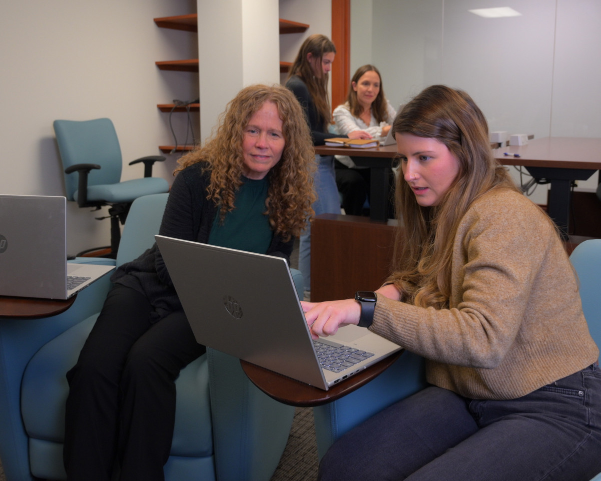 Training Room with Monica and Mallory looking at a computer